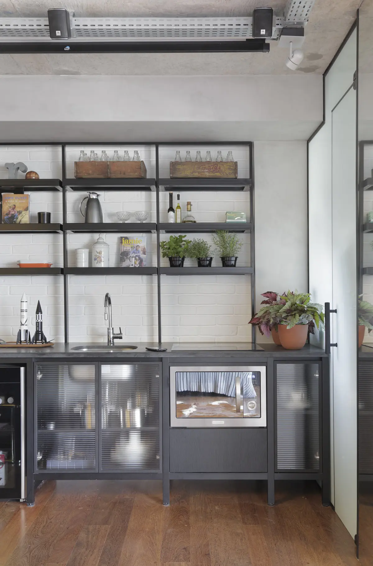 Cocina industrial con estantes abiertos, mesada madera y plantas decorativas — proyecto RA Loft, por Studio Ro-ca