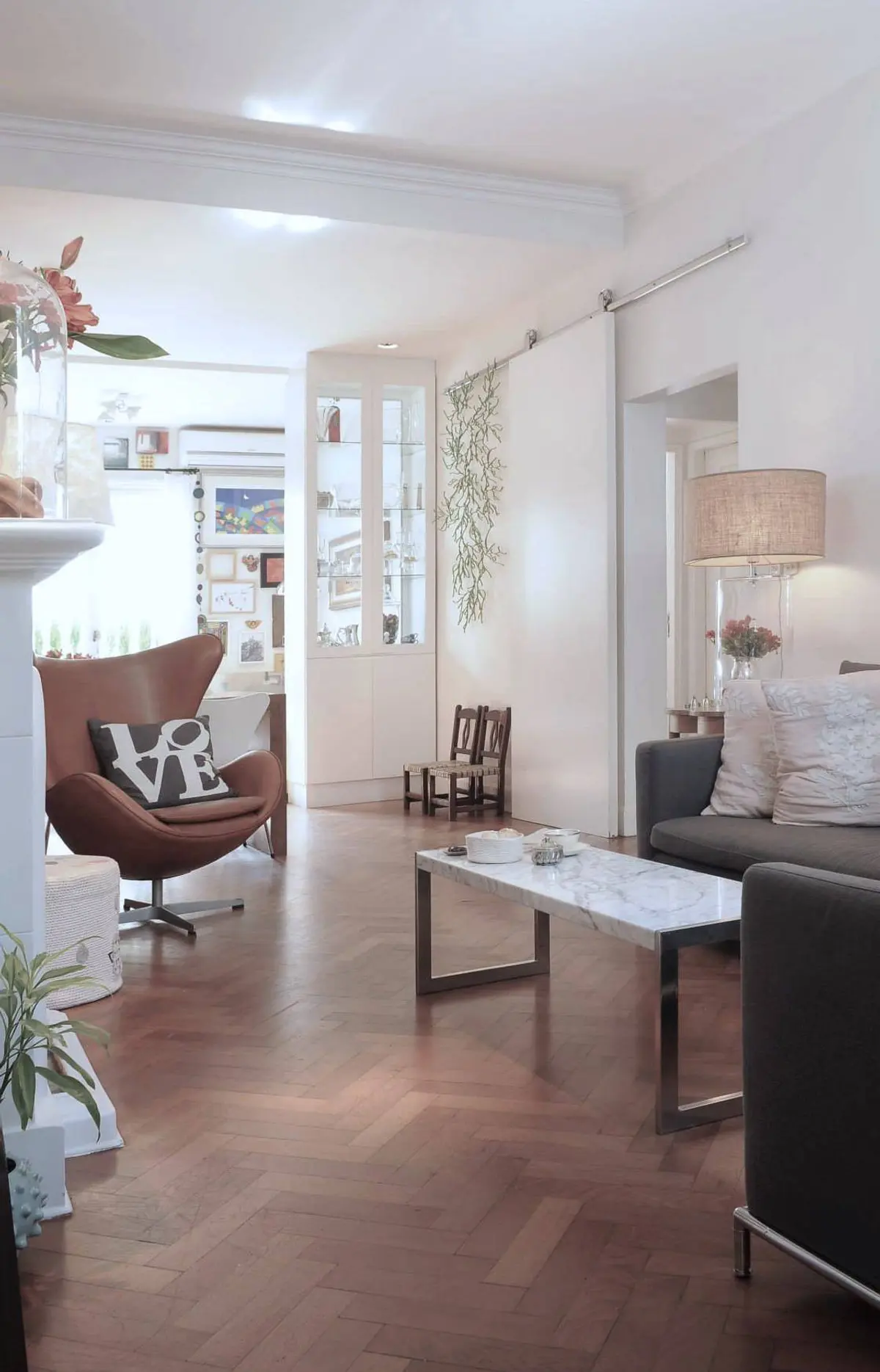 Living contemporáneo con sillón bordo, sofá gris y piso de madera — proyecto Santa Fe, por Estudio Diez Muzzio, en CABA