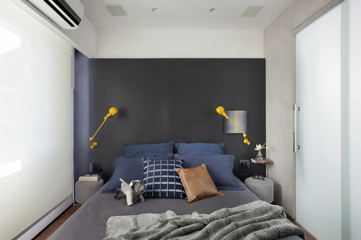 Dormitorio minimalista con pared gris, cama azul y lámparas doradas — proyecto RF House, por Studio Ro-ca