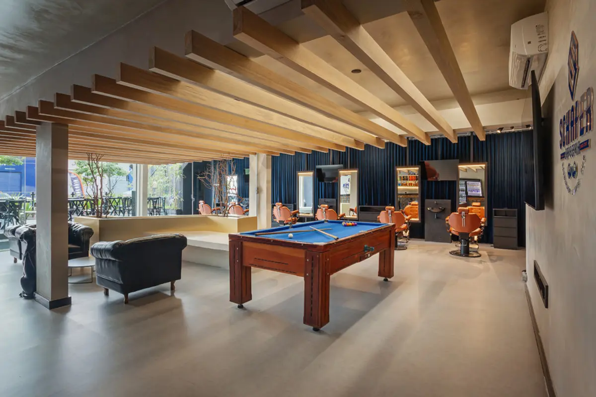 Galería moderna con techo de vigas de madera, mesa de billar y muebles negros — proyecto SCHAPER BARBEARIA, por Frederico Bicalho Arquitetura