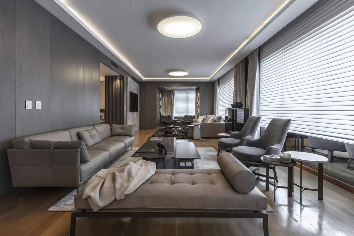 Sala de estar moderna com sofá modular cinza e paredes de madeira — projeto Departamento Edificio El Faro, por Viviana Melamed, em CABA