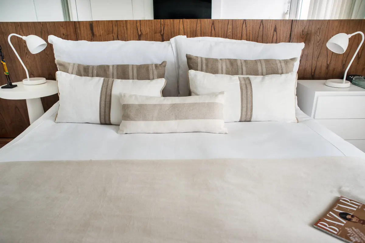 Dormitorio moderno con cama king y luces de pared de latón — proyecto La Pampa, por Estudio Basa, en CABA