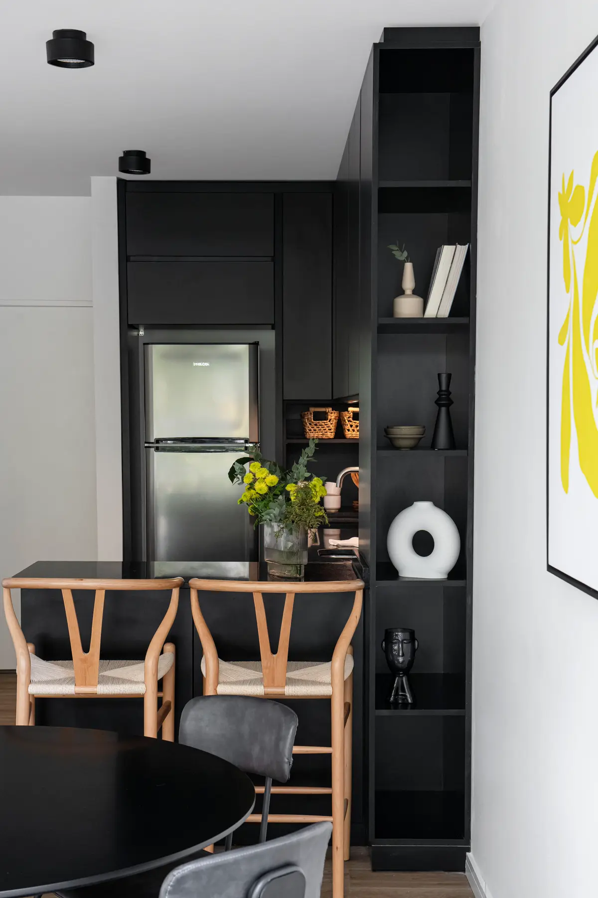 Cocina moderna escandinava con isla, sillas wishbone y estantería alta negra — proyecto 11 de Septiembre, por estudio VARA , en Belgrano