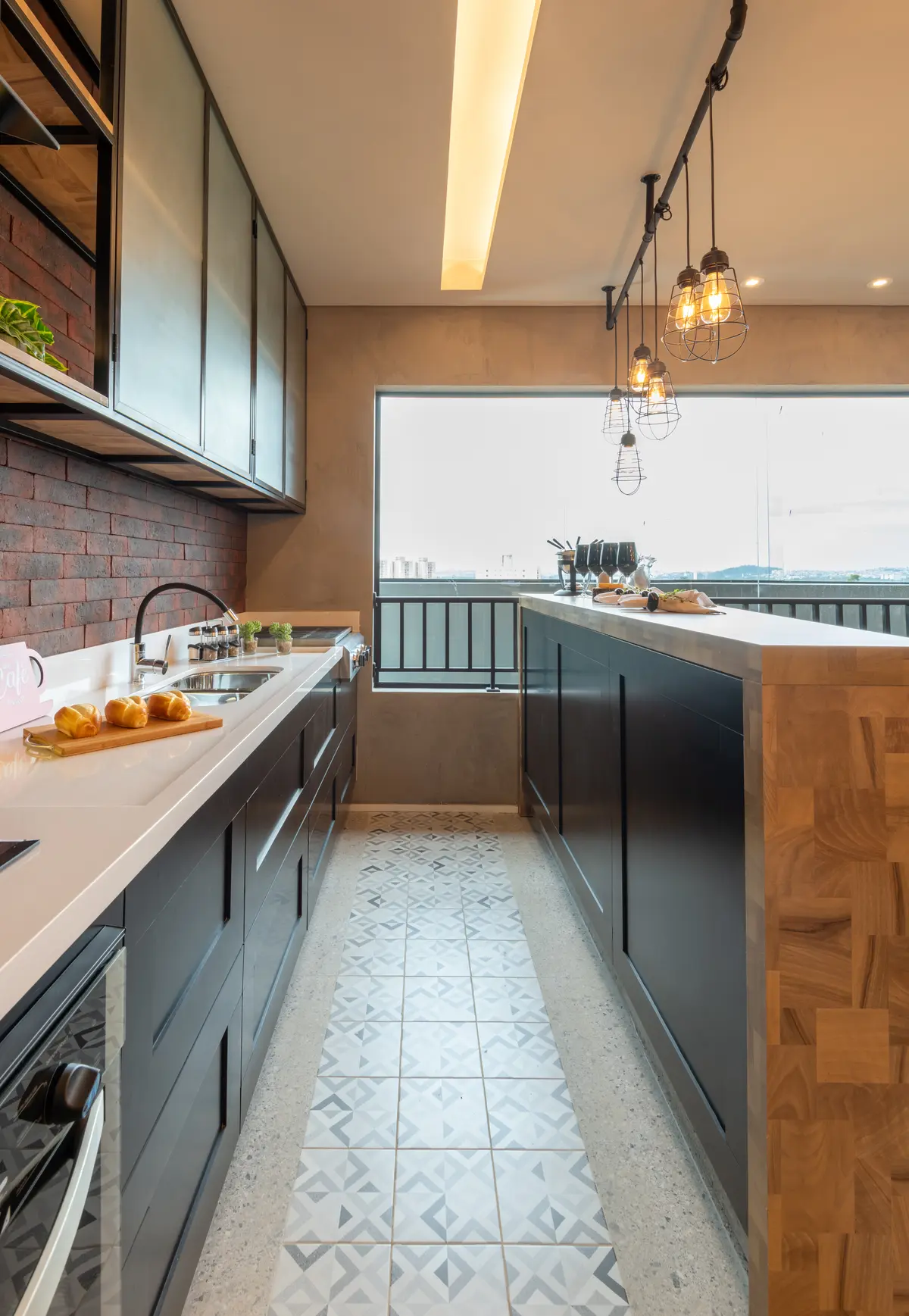 Cocina moderna abierta a terraza con vista al río, diseño minimalista y terminaciones premium — proyecto Brick 1, por Pricila Dalzochio