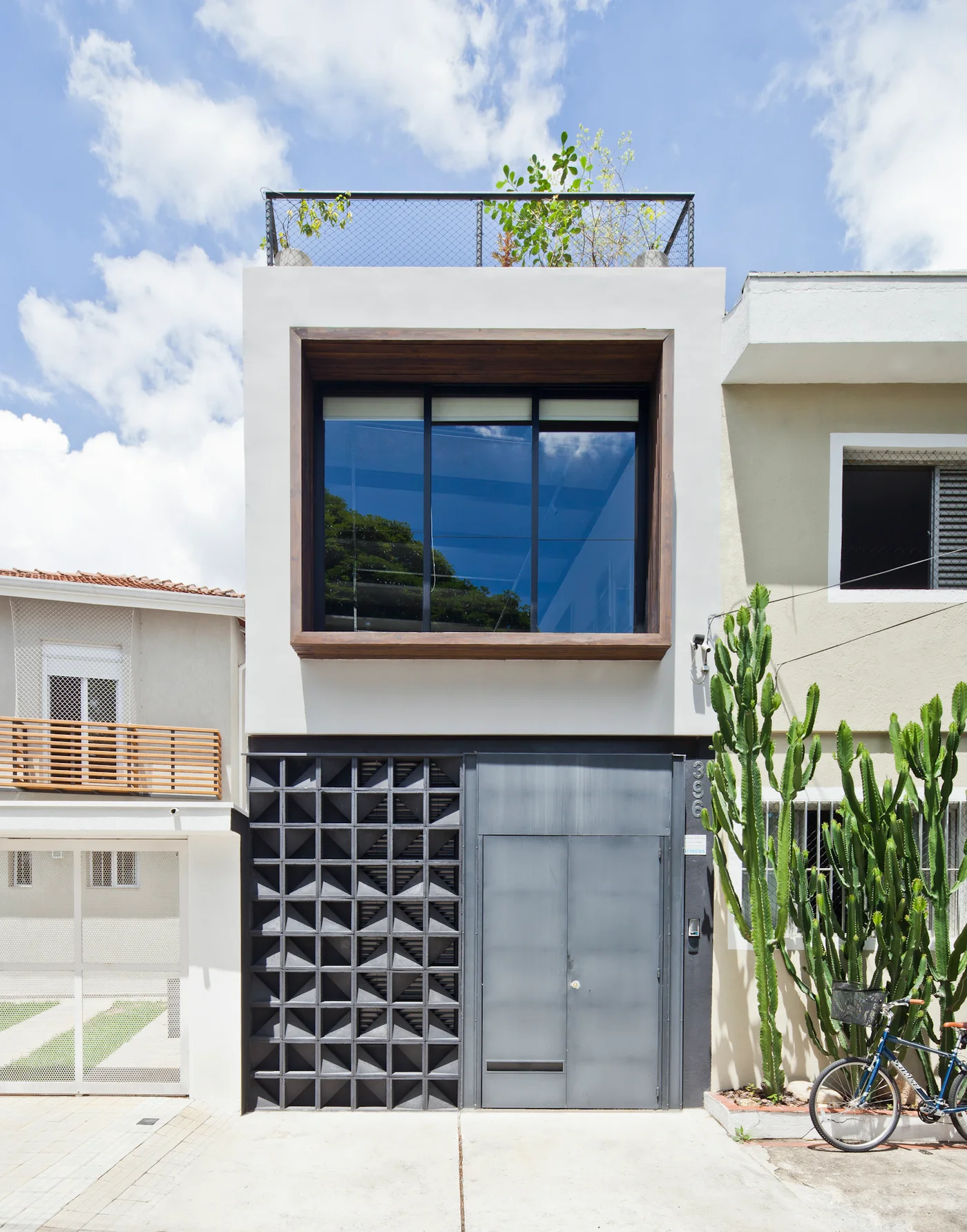 Fachada moderna de casa con bloques de hormigón y cactus.