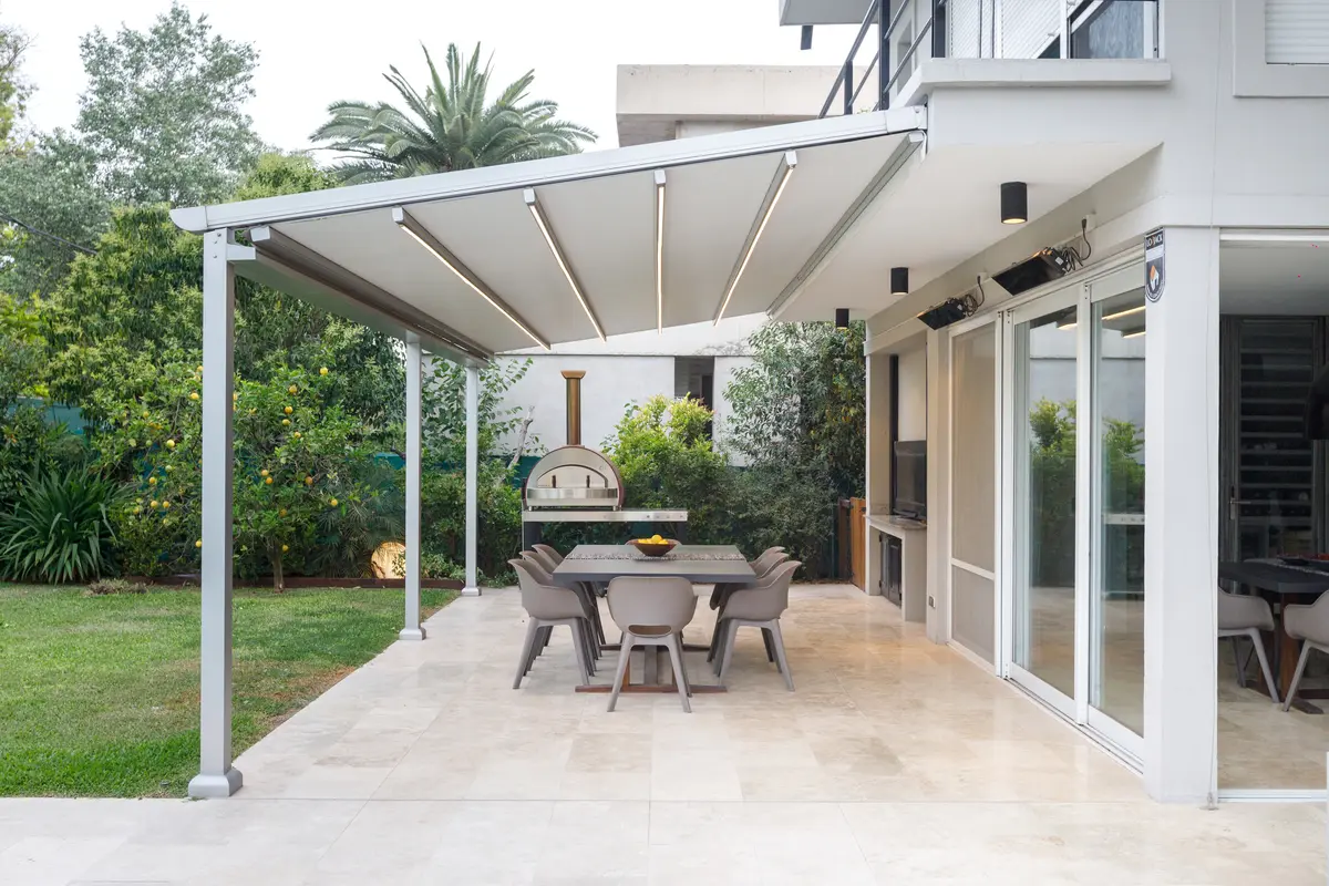 Churrasqueira moderna com pérgola retrátil e área de jantar externa — projeto TOLDER - PERGOLAS, por Argentina en Obra 2024, em Rincón de Milberg