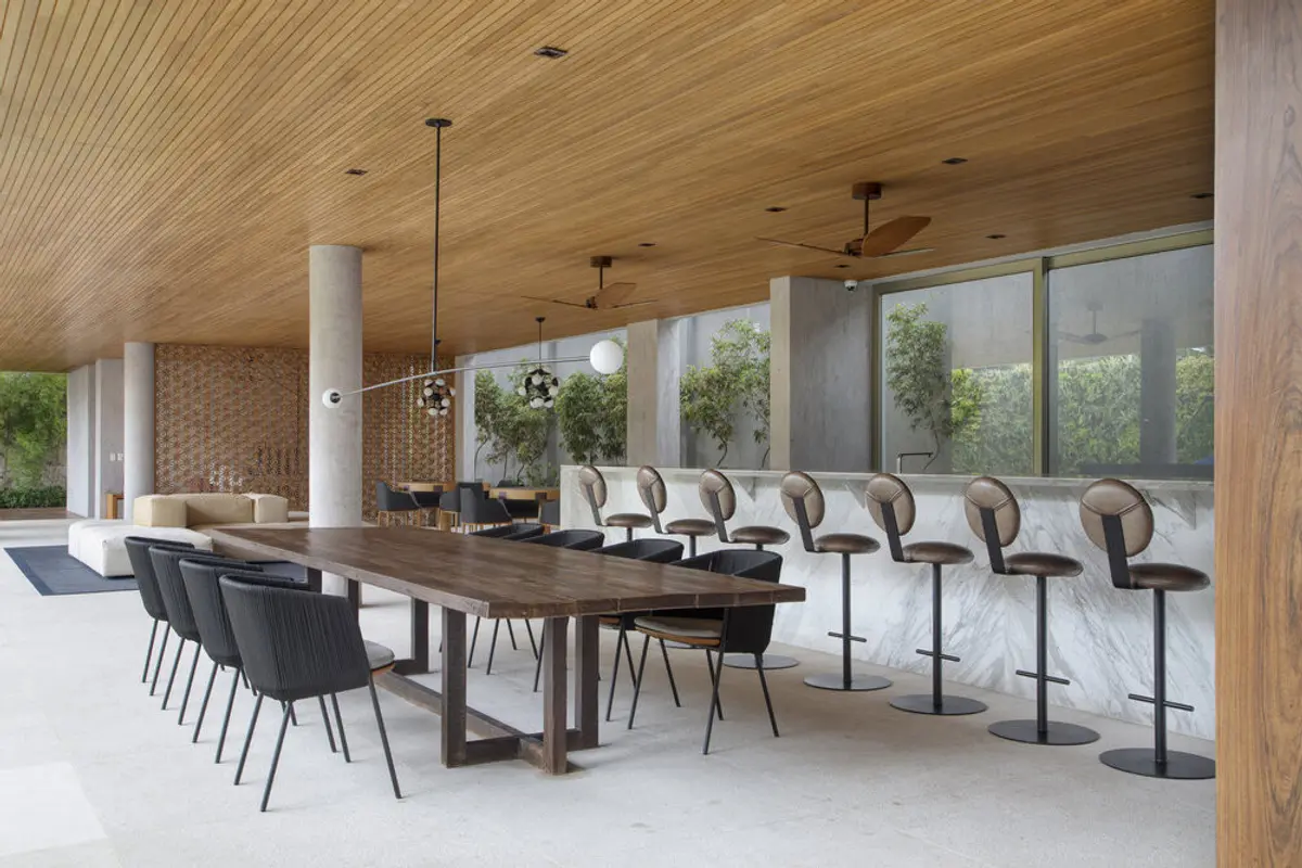 Comedor moderno con mesa de madera y ventanales amplios — proyecto BM House, por Studio Ro-ca