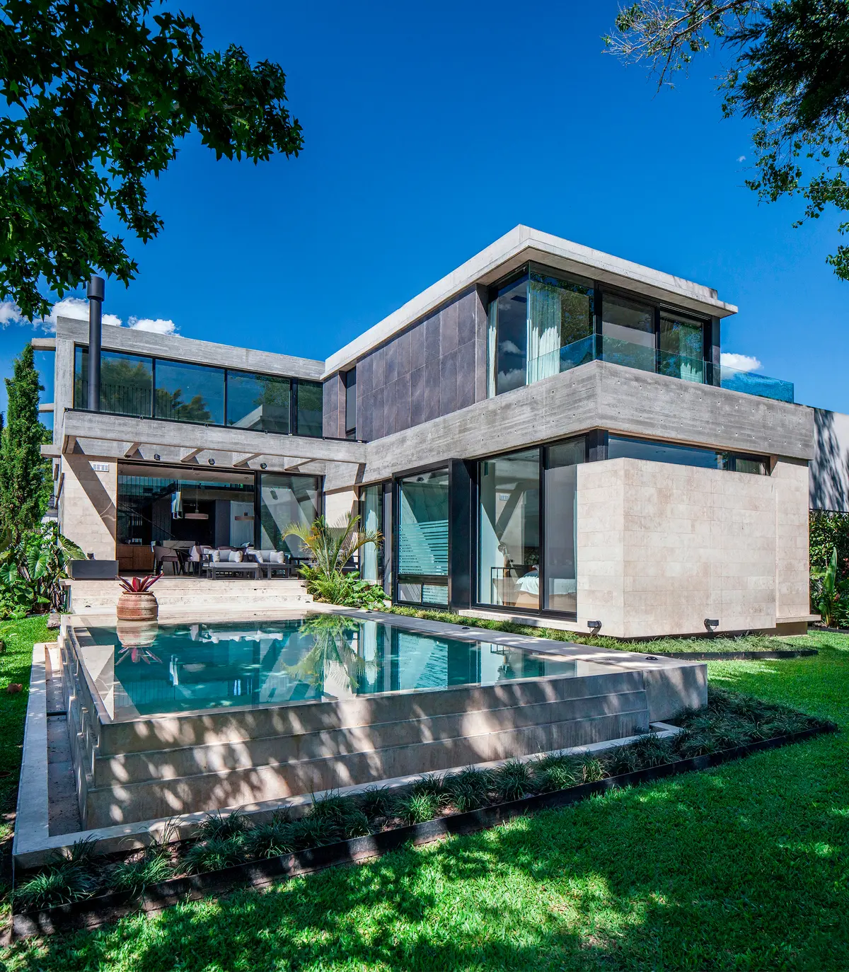 Fachada moderna com piscina e concreto aparente — projeto Casa Y, por Jorgelina Tortorici & asoc., em B1846 Adrogué