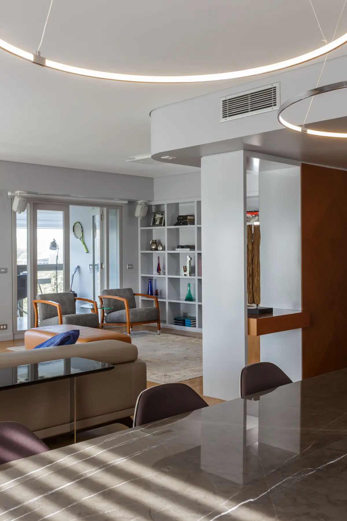 Living comedor moderno con estanterías modulares y luces indirectas — proyecto Piso en Belgrano, por Gutman+Lehrer Arquitectas, en Belgrano