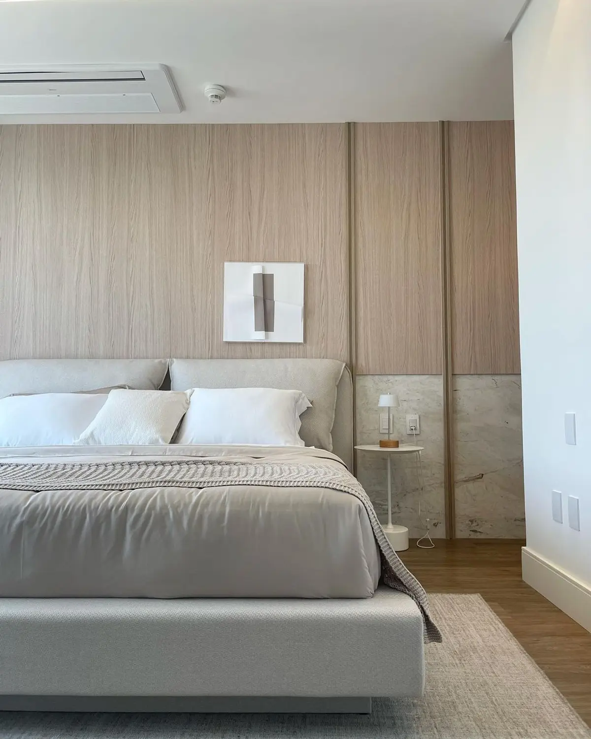 Quarto minimalista com paredes de madeira, cama grande e paleta neutra — projeto Balneário Yate House, por Camila Amin Design de Interiores, em Camboriú