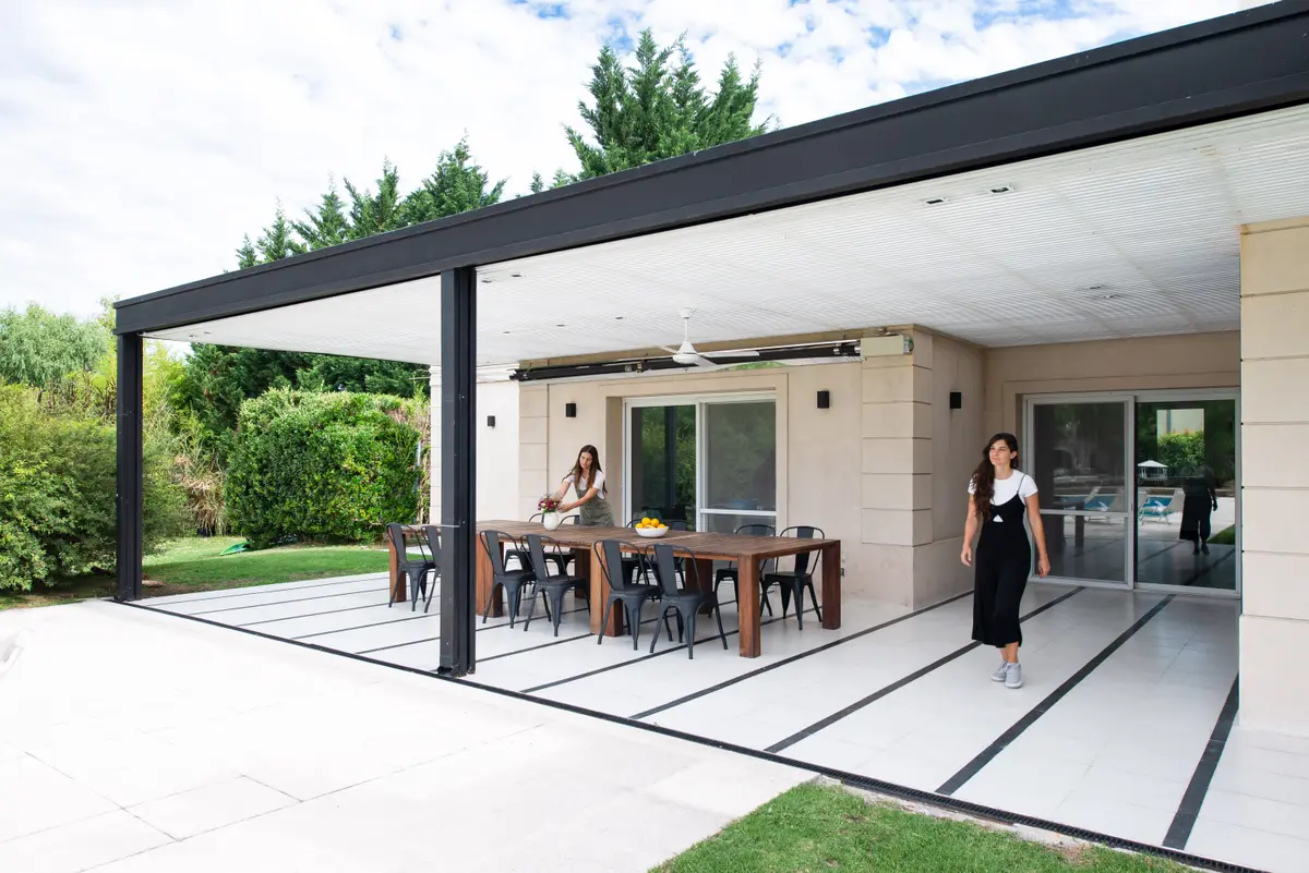 Área gourmet moderna externa com mesa de jantar e cadeiras — projeto Santa Maria De Tigre, por Parq Estudio, em Tigre