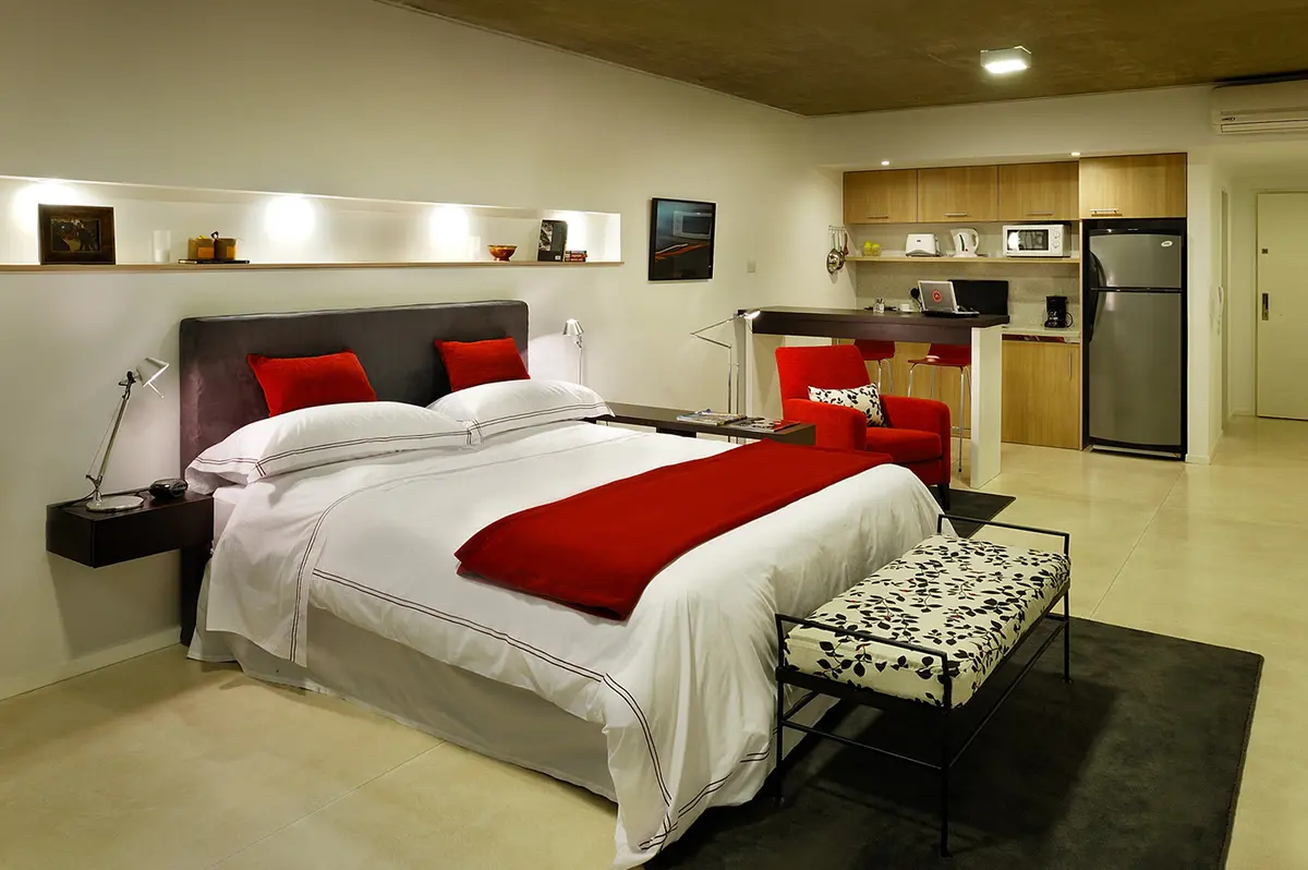 Monoambiente moderno con cocina integrada y cama protagonista — proyecto Ravignani Studios, por Mazzinghi Sanchez, en Palermo