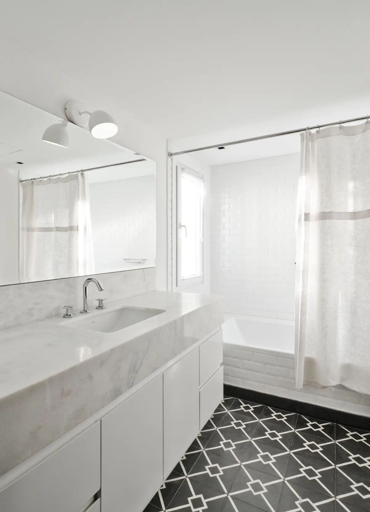 Baño moderno con suelo de mosaico geométrico, muebles blancos y mármol — proyecto Casa BA, por Estudio Dado, en Pilar