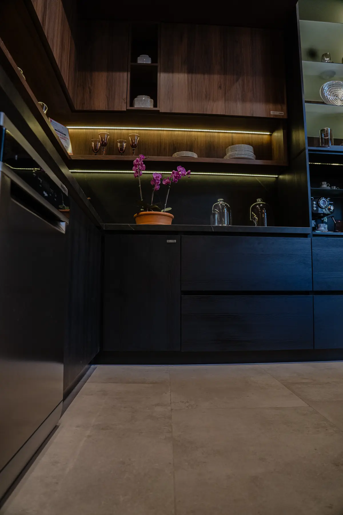Cozinha moderna com armários de madeira escura e piso de pedra — projeto Cocina | Casa DIR 2024, por San Lorenzo Design, em San Salvador de Jujuy